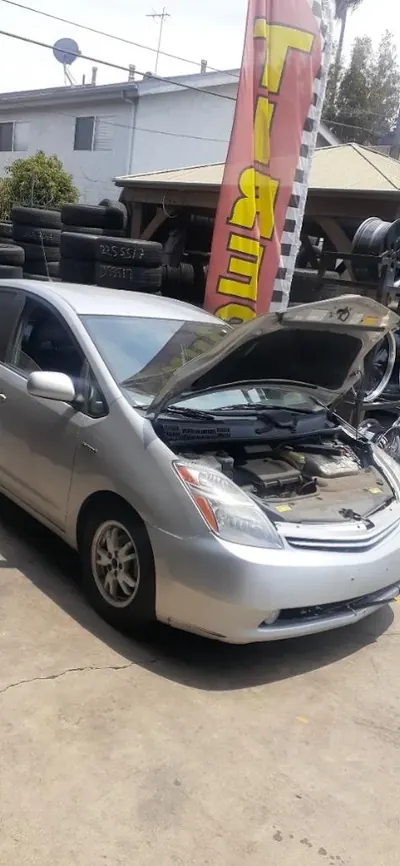 Silver Toyota Prius with its hood open for service at Hybrid 310